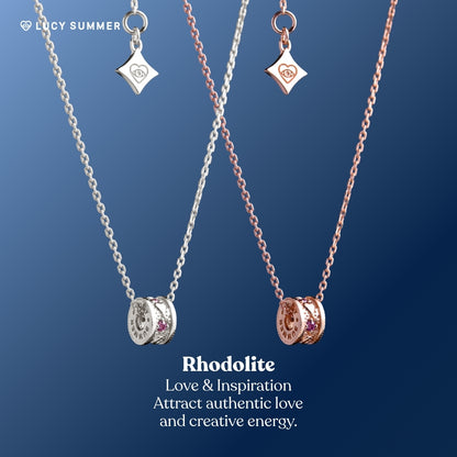 LunaOne-Mini-Rhodolite Two necklaces with charms on a blue background, featuring the brand 'Lucy Summer'.