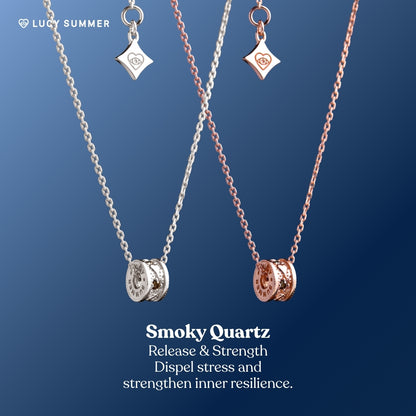 LunaOne-Mini-Smoky_Quartz-Two necklaces with charms on a blue background, featuring 'Smoky Quartz' text.