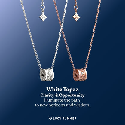 LunaOne-Mini-White Topaz Two necklaces with white topaz pendants on a blue background, featuring the brand 'Lucy Summer'.