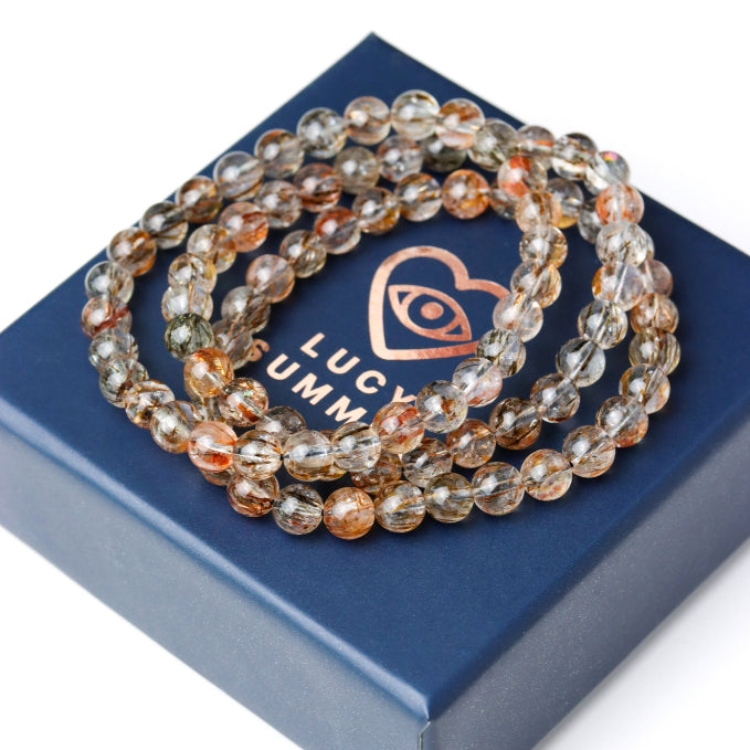 LUCY SUMMER กำไลข้อมือหินแท้ Black Gold Super Seven Rutile Quartz แบล็คโกลด์ซุปเปอร์เซเว่น ขนาด 7 mm.