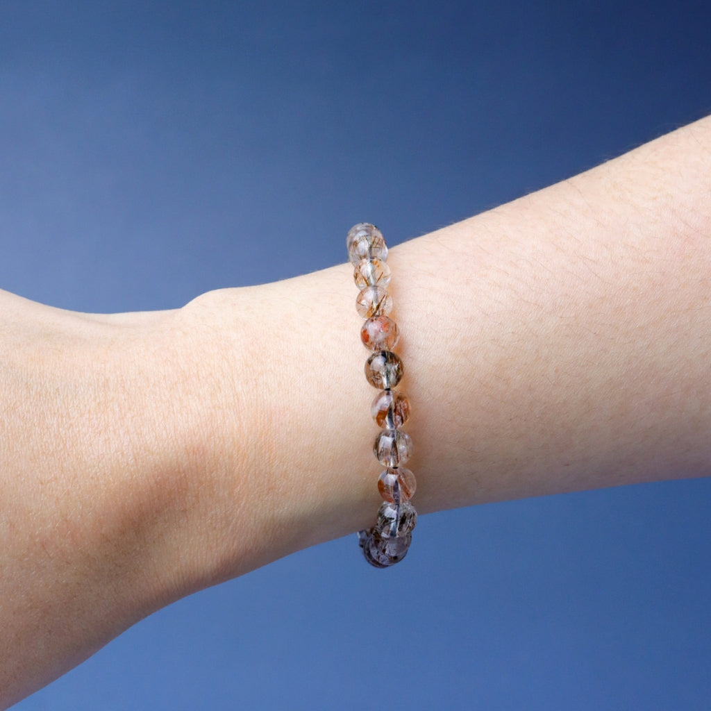 LUCY SUMMER กำไลข้อมือหินแท้ Black Gold Super Seven Rutile Quartz แบล็คโกลด์ซุปเปอร์เซเว่น ขนาด 7 mm.